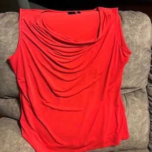 Sleeveless red blouse goes great with a black or gray sweater.